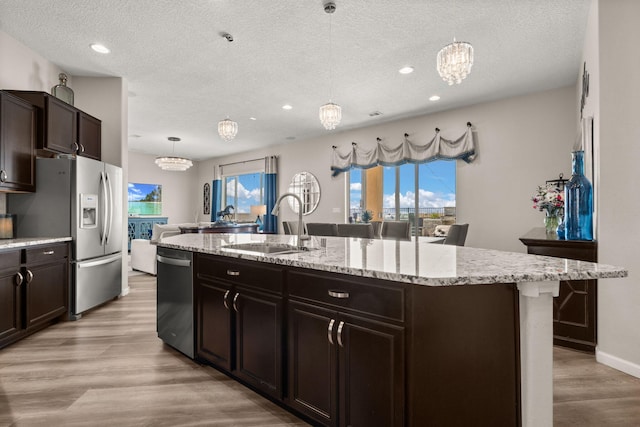 9128 Vista Bosquejo Rd NW, Albuquerque, NM 87120 - kitchen with appliances with stainless steel finishes, a chandelier, a textured ceiling, recessed lighting, and a center island with sink