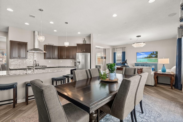 9128 Vista Bosquejo Rd NW, Albuquerque, NM 87120 - dining space with light wood-style floors, recessed lighting, and a chandelier
