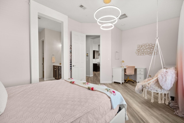9128 Vista Bosquejo Rd NW, Albuquerque, NM 87120 - bedroom with wood finished floors, a chandelier, an office area, and ensuite bath