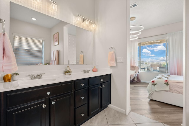 9128 Vista Bosquejo Rd NW, Albuquerque, NM 87120 - ensuite bathroom featuring double vanity and baseboards