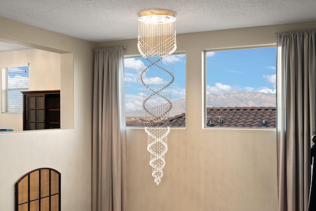 9128 Vista Bosquejo Rd NW, Albuquerque, NM 87120 - detailed view of a chandelier and a textured ceiling