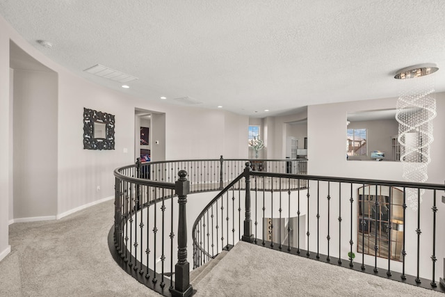 9128 Vista Bosquejo Rd NW, Albuquerque, NM 87120 - corridor with carpet floors, an upstairs landing, a textured ceiling, and recessed lighting