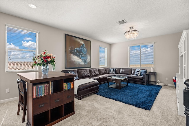 9128 Vista Bosquejo Rd NW, Albuquerque, NM 87120 - carpeted living area with a textured ceiling and a chandelier