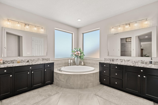 9128 Vista Bosquejo Rd NW, Albuquerque, NM 87120 - bathroom with two vanities, a garden tub, and tile patterned floors