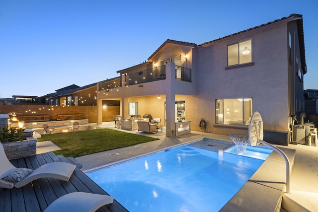 9128 Vista Bosquejo Rd NW, Albuquerque, NM 87120 - back of property with a balcony, outdoor lounge area, exterior kitchen, and stucco siding
