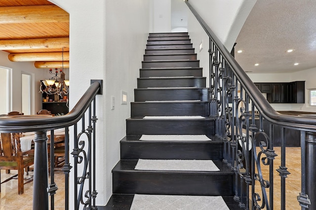 2061 Blaylock Ln NE, Los Lunas, NM 87031 - stairs featuring recessed lighting, a chandelier, and arched walkways