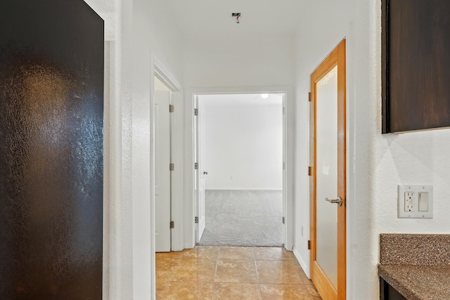 2061 Blaylock Ln NE, Los Lunas, NM 87031 - hallway with light colored carpet and light tile patterned floors