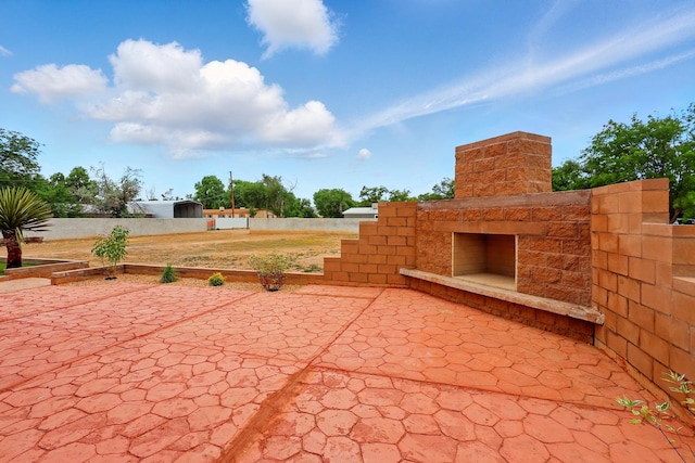 2061 Blaylock Ln NE, Los Lunas, NM 87031 - view of patio / terrace with an outdoor stone fireplace