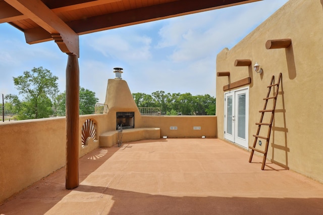 2061 Blaylock Ln NE, Los Lunas, NM 87031 - view of patio with a large fireplace and french doors