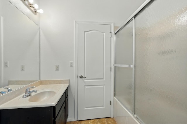 2061 Blaylock Ln NE, Los Lunas, NM 87031 - bathroom featuring vanity and combined bath / shower with glass door