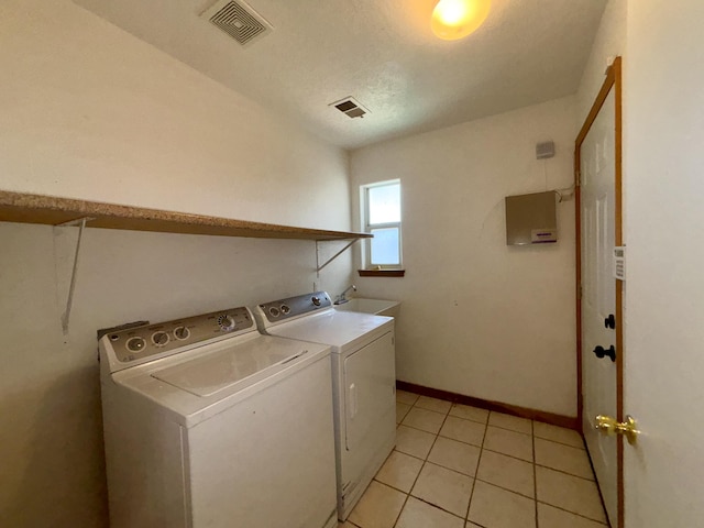 2172 Sonora Rd NE, Rio Rancho, NM 87144 - laundry room featuring washer and clothes dryer, baseboards, and light tile patterned flooring