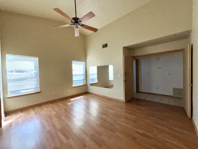 2172 Sonora Rd NE, Rio Rancho, NM 87144 - spare room featuring high vaulted ceiling, light wood-style floors, ceiling fan, and baseboards
