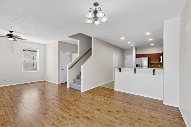 11024 Fort Point Ln NE Unit B, Albuquerque, NM 87123 - unfurnished living room featuring light wood-style flooring, a ceiling fan, stairway, recessed lighting, and baseboards