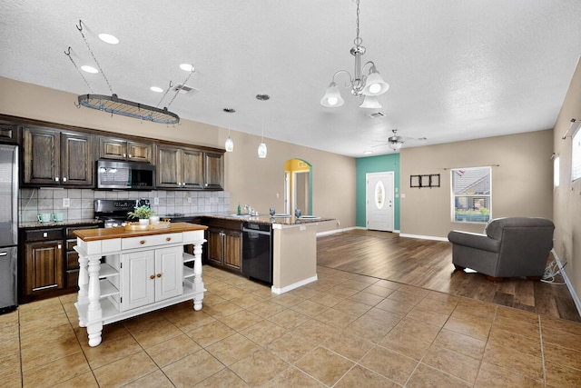 805 Palo Duro Dr, Bernalillo, NM 87004 - kitchen featuring stainless steel appliances, open shelves, open floor plan, wood counters, and a textured ceiling