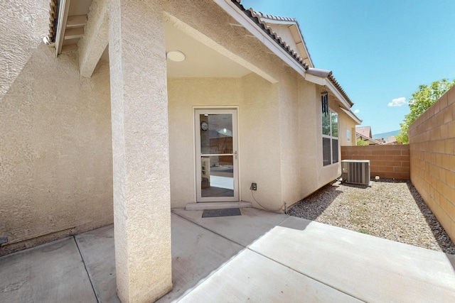 805 Palo Duro Dr, Bernalillo, NM 87004 - view of exterior entry featuring stucco siding, a patio, and a tile roof