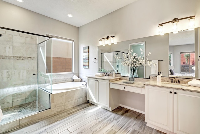 843 Mesa Roja Trl NE, Rio Rancho, NM 87124 - full bath featuring a stall shower, double vanity, a bath, and wood finished floors