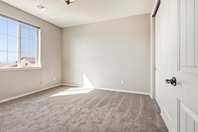 843 Mesa Roja Trl NE, Rio Rancho, NM 87124 - carpeted empty room with plenty of natural light, a textured ceiling, and baseboards