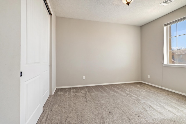 843 Mesa Roja Trl NE, Rio Rancho, NM 87124 - carpeted empty room with a textured ceiling and baseboards