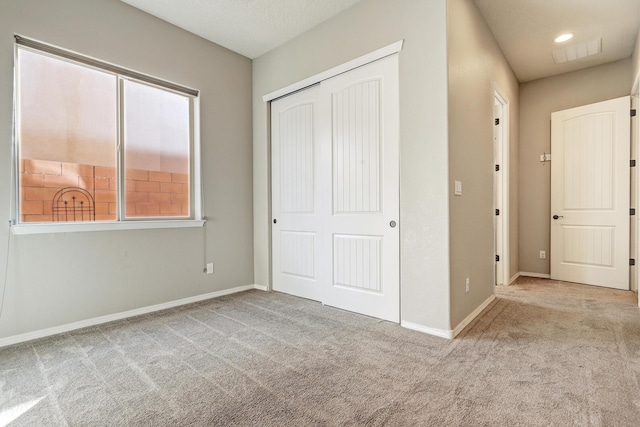 843 Mesa Roja Trl NE, Rio Rancho, NM 87124 - unfurnished bedroom with carpet floors, a closet, and baseboards