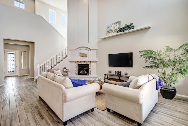 843 Mesa Roja Trl NE, Rio Rancho, NM 87124 - living room with a high ceiling, light wood finished floors, baseboards, and healthy amount of natural light