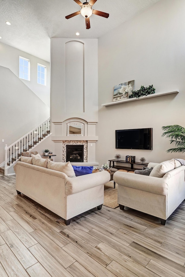 843 Mesa Roja Trl NE, Rio Rancho, NM 87124 - living room with light wood-style flooring, recessed lighting, a ceiling fan, stairway, and a high ceiling