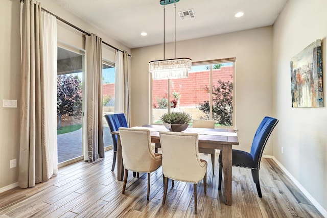 843 Mesa Roja Trl NE, Rio Rancho, NM 87124 - dining area featuring a chandelier, wood finished floors, baseboards, and recessed lighting