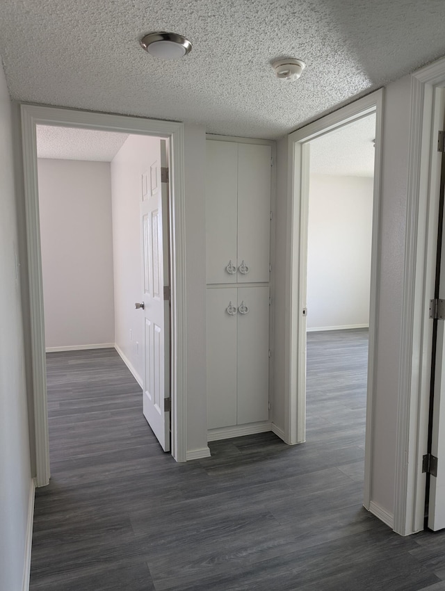 301 Stagecoach Dr, Elephant Butte, NM 87935 - hall featuring dark wood finished floors, baseboards, and a textured ceiling