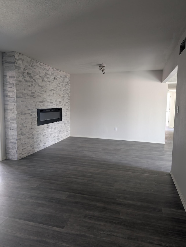 301 Stagecoach Dr, Elephant Butte, NM 87935 - unfurnished living room with a stone fireplace and wood finished floors