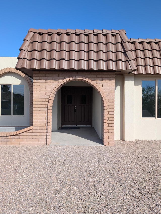 301 Stagecoach Dr, Elephant Butte, NM 87935 - view of property exterior featuring a tiled roof and brick siding