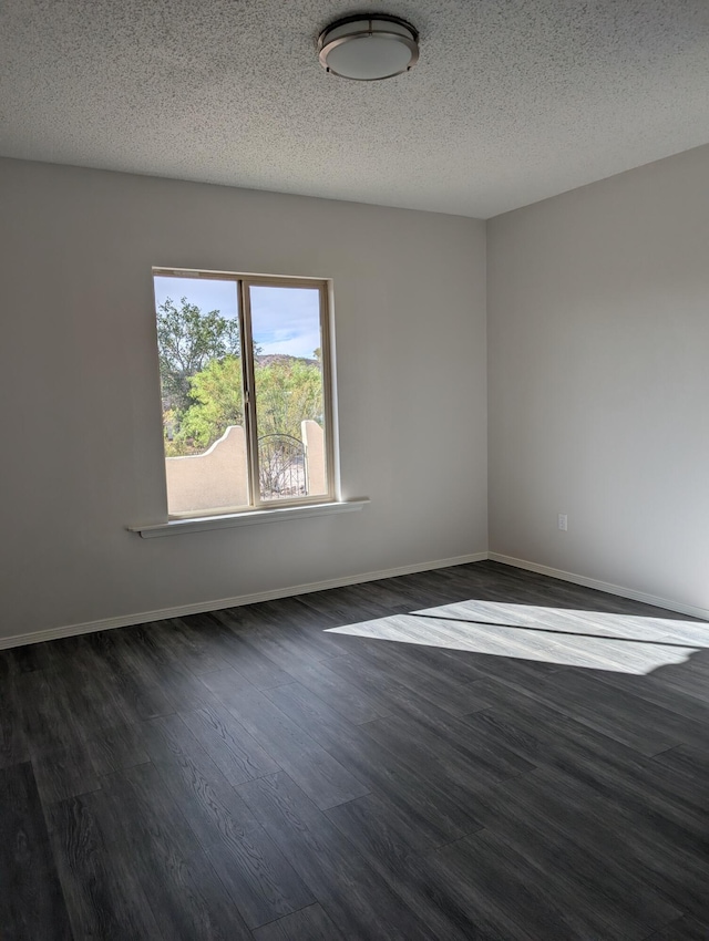 301 Stagecoach Dr, Elephant Butte, NM 87935 - empty room featuring dark wood-style flooring, a textured ceiling, and baseboards