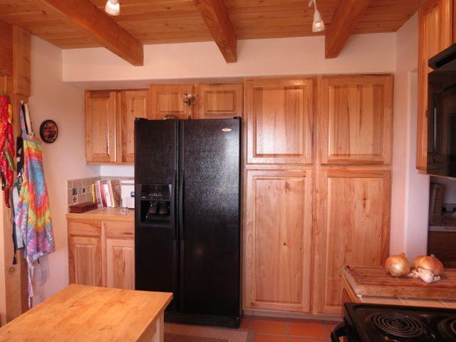 403 Candy Kitchen Rd, Ramah, NM 87321 - kitchen featuring black refrigerator with ice dispenser, wood ceiling with exposed beams, and wooden counters
