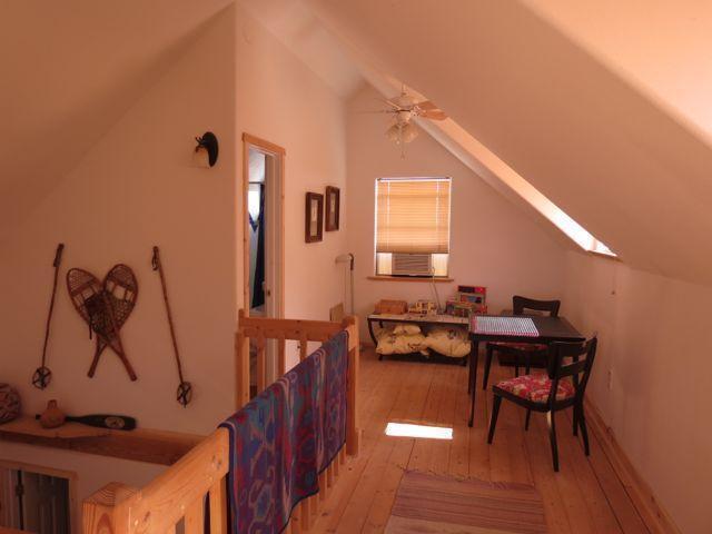 403 Candy Kitchen Rd, Ramah, NM 87321 - additional living space with lofted ceiling, hardwood / wood-style flooring, a ceiling fan, and a skylight