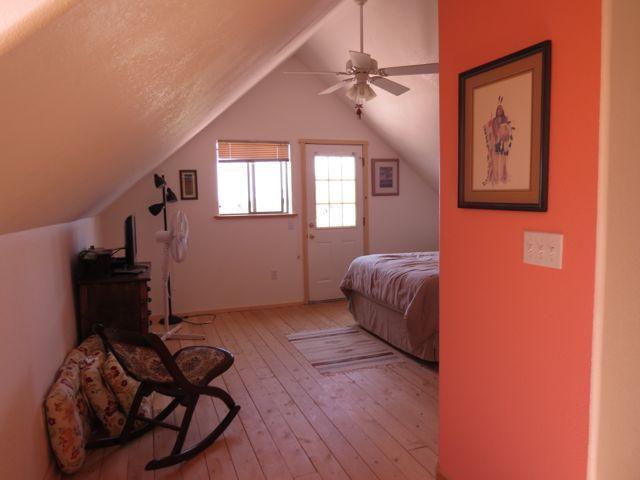 403 Candy Kitchen Rd, Ramah, NM 87321 - bedroom with light wood-style flooring, lofted ceiling, and a ceiling fan