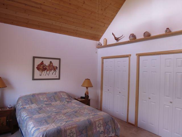 403 Candy Kitchen Rd, Ramah, NM 87321 - bedroom with lofted ceiling, two closets, wooden ceiling, and carpet