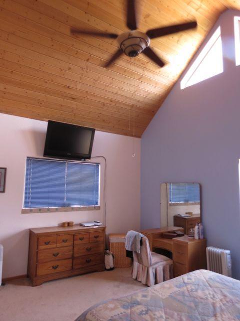 403 Candy Kitchen Rd, Ramah, NM 87321 - bedroom featuring radiator heating unit, lofted ceiling, carpet flooring, wooden ceiling, and ceiling fan