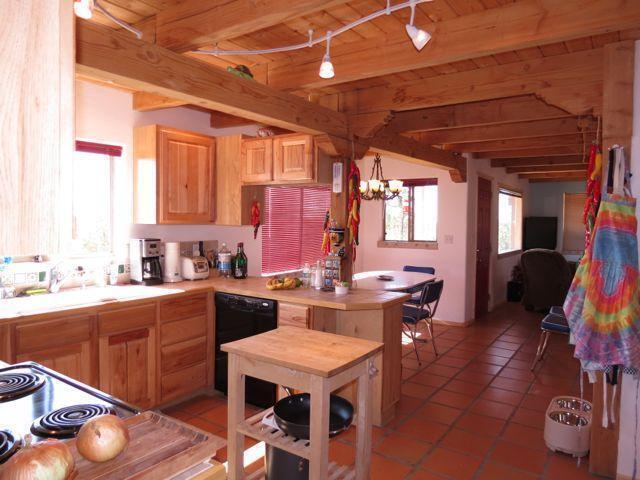 403 Candy Kitchen Rd, Ramah, NM 87321 - kitchen featuring dishwasher, light countertops, a chandelier, light tile patterned floors, and wooden ceiling with exposed beams