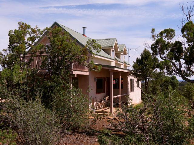 403 Candy Kitchen Rd, Ramah, NM 87321 - view of home's exterior featuring stucco siding, a patio, and metal roof