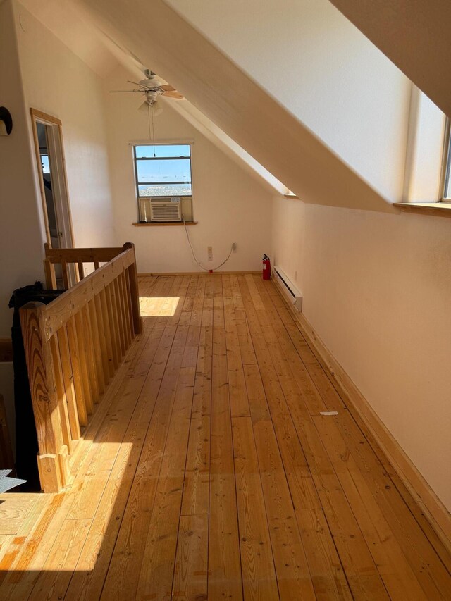 403 Candy Kitchen Rd, Ramah, NM 87321 - additional living space with vaulted ceiling, a baseboard radiator, light wood-style floors, ceiling fan, and cooling unit