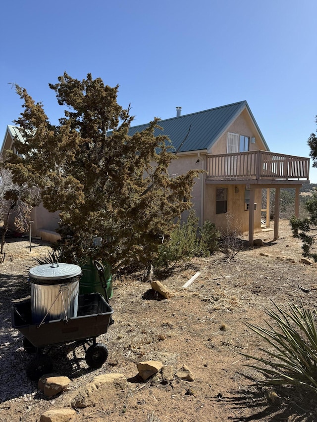 403 Candy Kitchen Rd, Ramah, NM 87321 - back of property with stucco siding, metal roof, and a deck