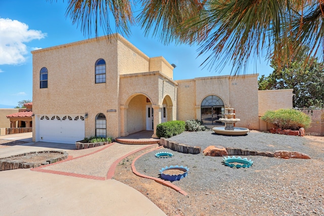 1551 Valley View Dr SW, Los Lunas, NM 87031 - mediterranean / spanish-style house with stucco siding, a garage, and driveway