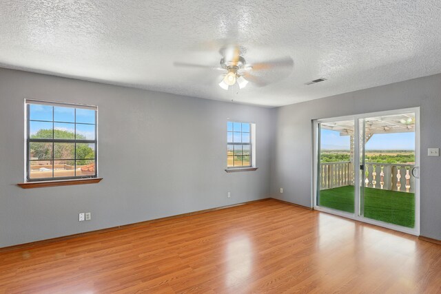 1551 Valley View Dr SW, Los Lunas, NM 87031 - spare room featuring ceiling fan, light wood-style floors, a textured ceiling, and baseboards