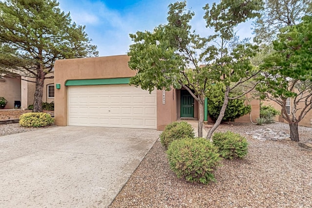 7623 Vista Alta Rd NW, Albuquerque, NM 87114 - southwest-style home featuring stucco siding, a garage, and driveway