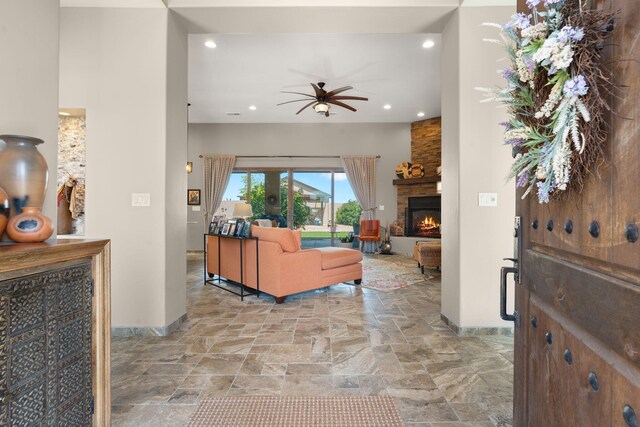 2633 Globe Ct NE, Rio Rancho, NM 87124 - living room featuring a stone fireplace, a ceiling fan, recessed lighting, and stone finish floors
