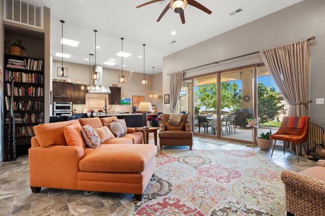 2633 Globe Ct NE, Rio Rancho, NM 87124 - living area with ceiling fan, stone tile floors, and recessed lighting