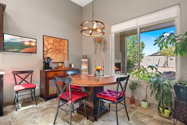 2633 Globe Ct NE, Rio Rancho, NM 87124 - dining space with stone finish flooring, a chandelier, and a high ceiling