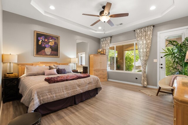 2633 Globe Ct NE, Rio Rancho, NM 87124 - bedroom featuring a tray ceiling, light wood finished floors, access to outside, recessed lighting, and ceiling fan