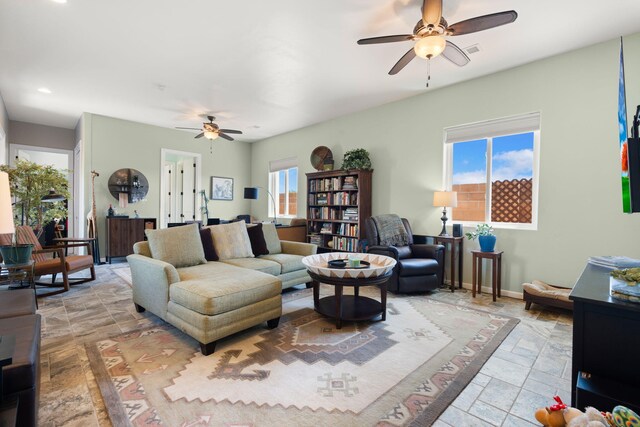 2633 Globe Ct NE, Rio Rancho, NM 87124 - living area featuring a ceiling fan and stone tile flooring