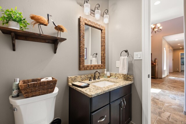 2633 Globe Ct NE, Rio Rancho, NM 87124 - bathroom with stone tile floors, vanity, recessed lighting, and a chandelier