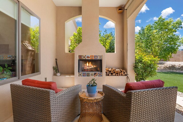 2633 Globe Ct NE, Rio Rancho, NM 87124 - view of patio featuring a lit fireplace
