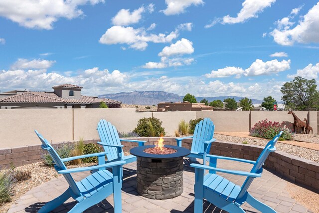 2633 Globe Ct NE, Rio Rancho, NM 87124 - view of patio / terrace with a fire pit and a mountain view